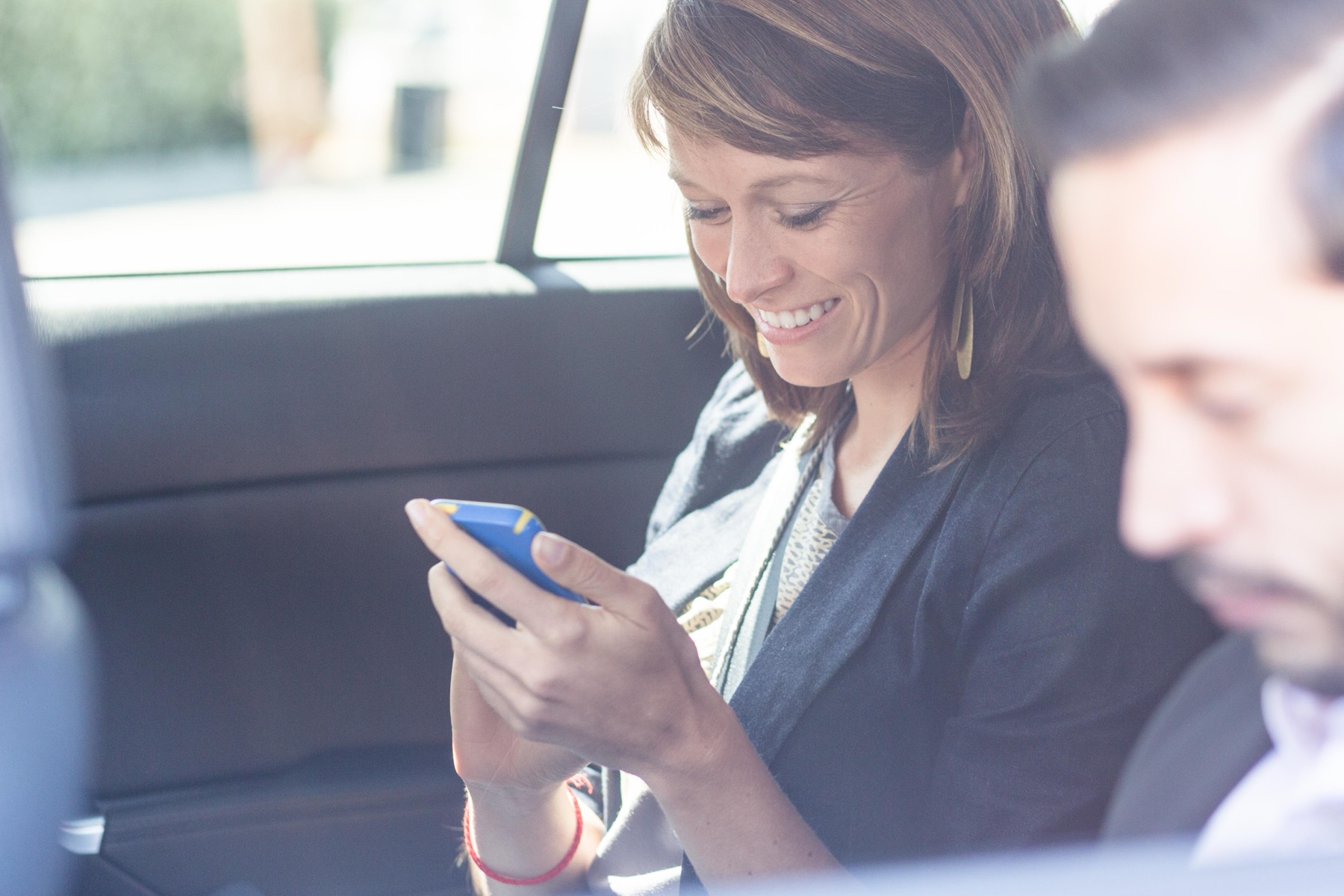 A commuter checking the wallet on their phone — the everyday moment of a verified reward